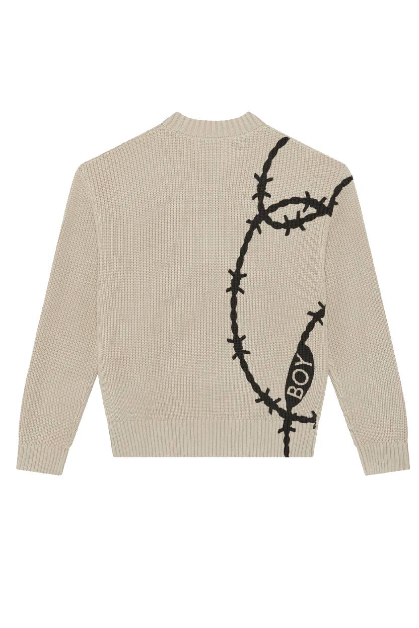 Beige sweater with black barbed wire design on the back, featuring the word 'BOY'.