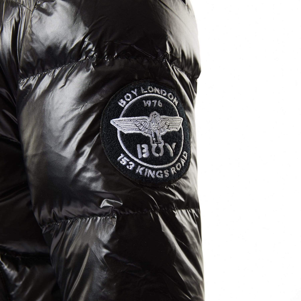 Model wearing Black BOY London puffer jacket with a hood on a white background