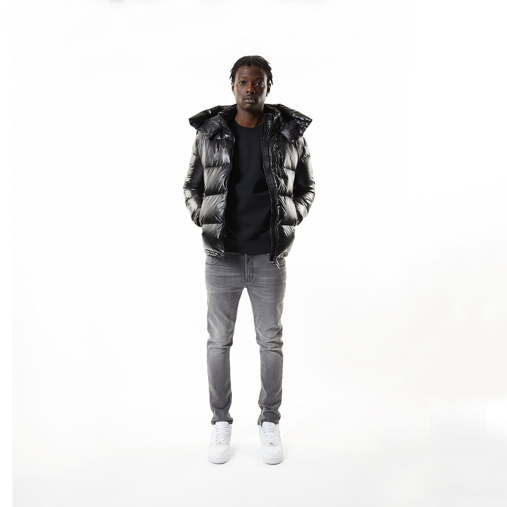Model wearing Black BOY London puffer jacket with a hood on a white background