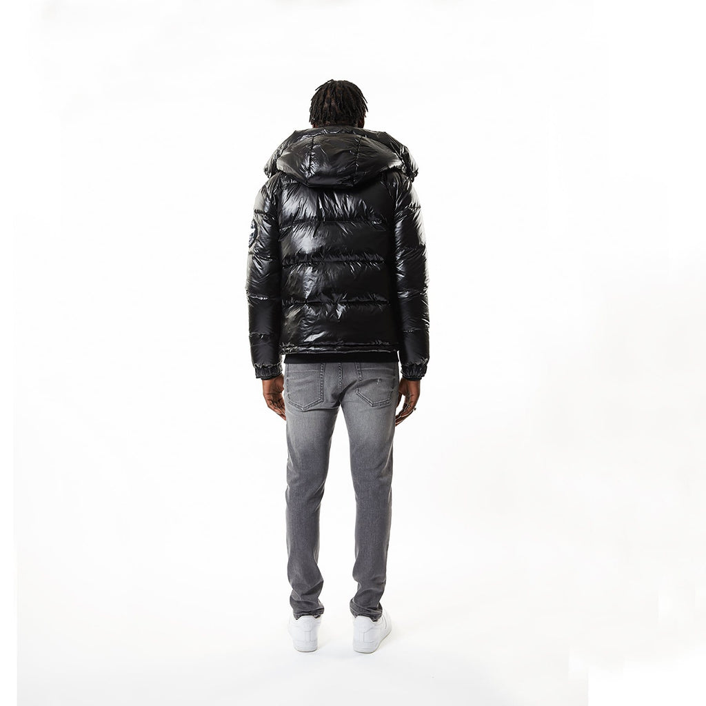 Model wearing Black BOY London puffer jacket with a hood on a white background