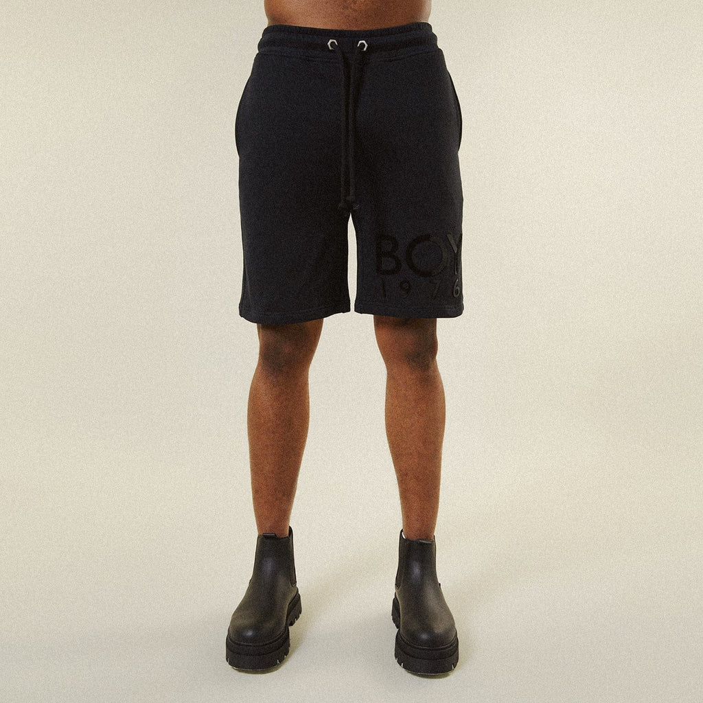 Model BOY London shorts on plain background 