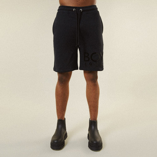 Model BOY London shorts on plain background 
