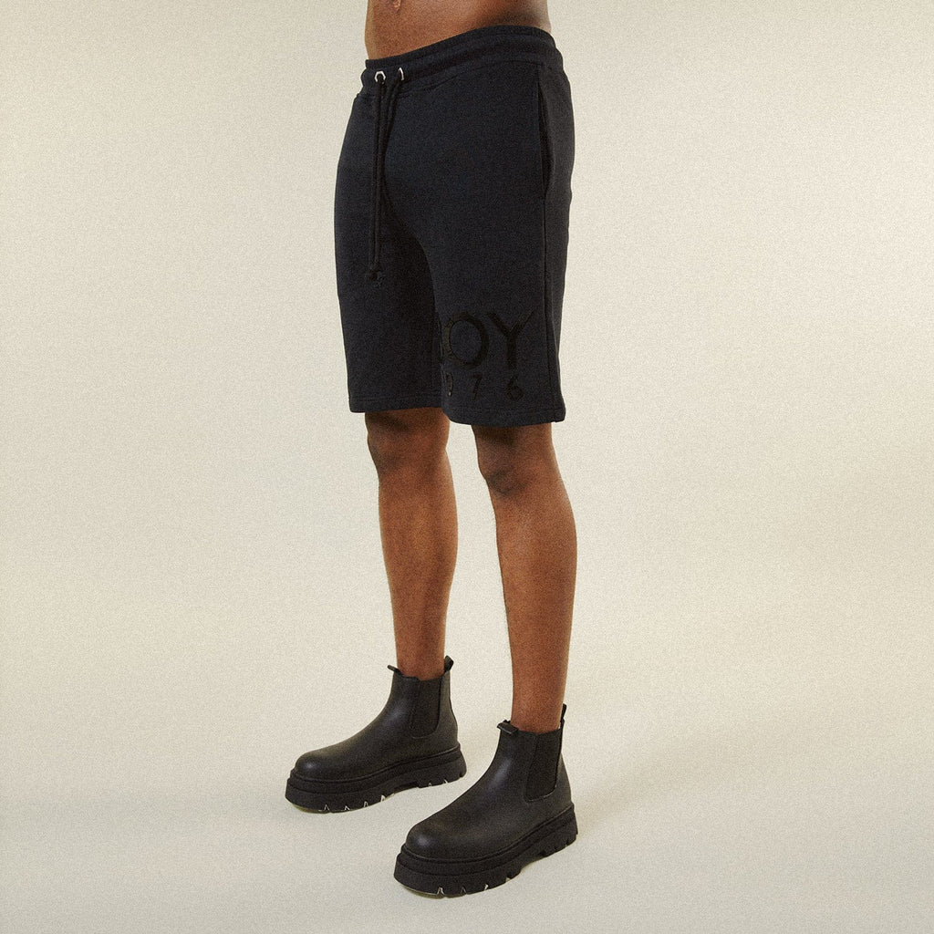 Model BOY London shorts on plain background 