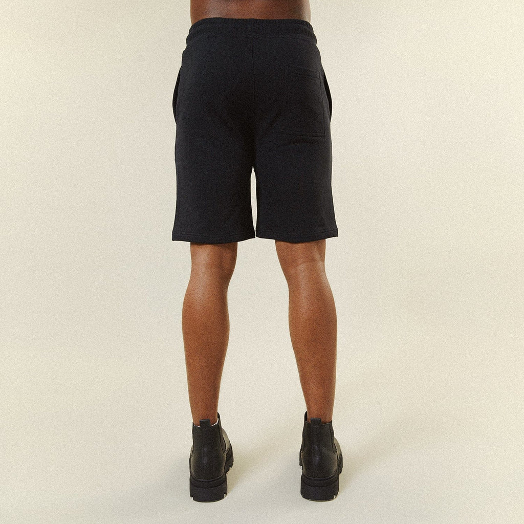 Model BOY London shorts on plain background 