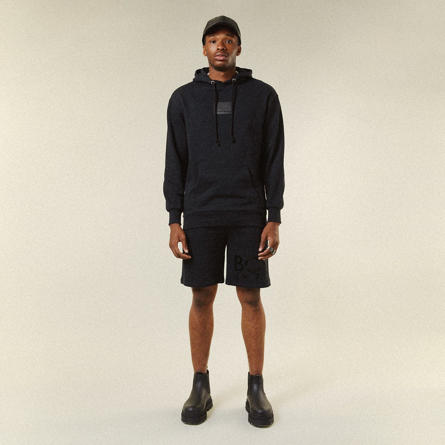 Model BOY London shorts on plain background 