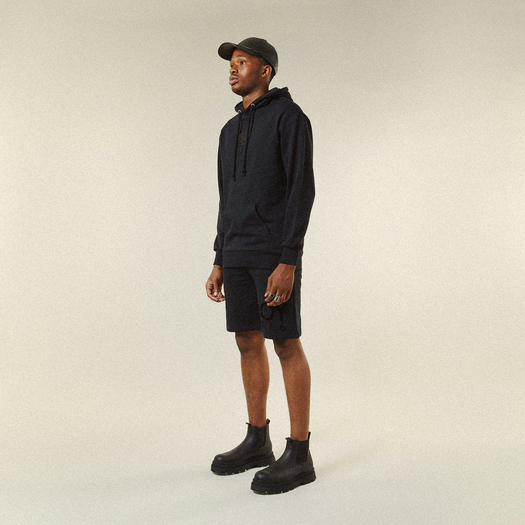 Model BOY London shorts on plain background 