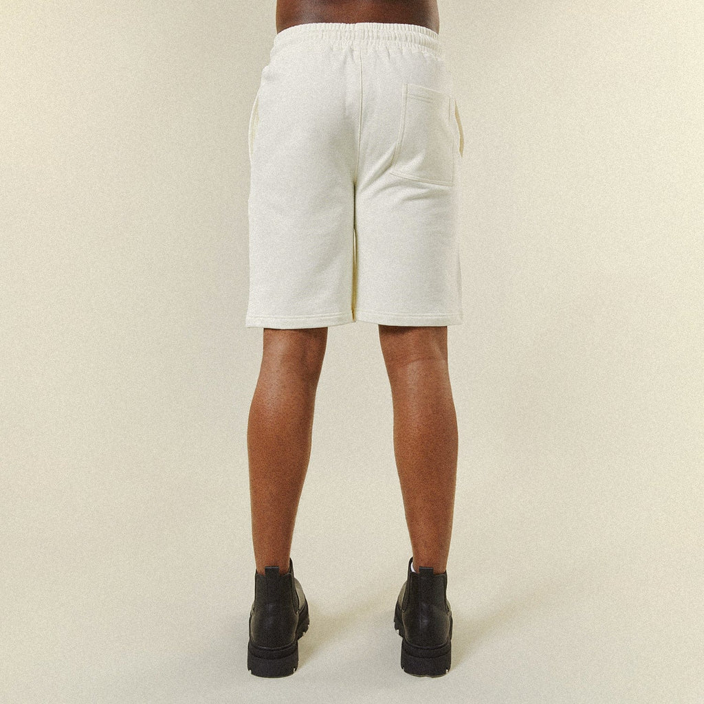 Model wearing BOY London shorts on plain background