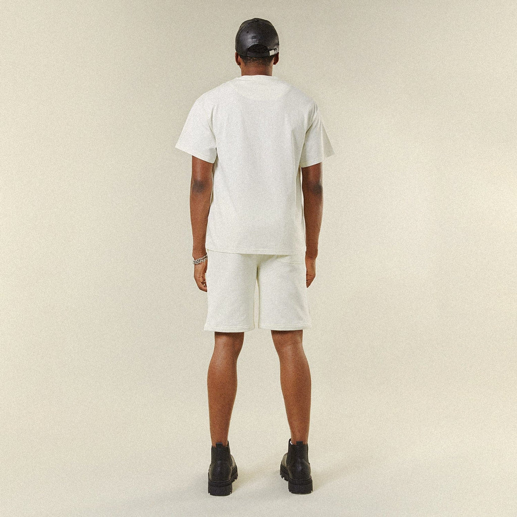 Model wearing BOY London shorts on plain background