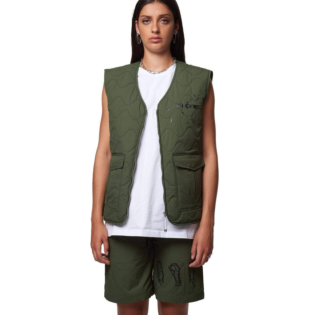 Female model wearing Boy London green gilet on white background