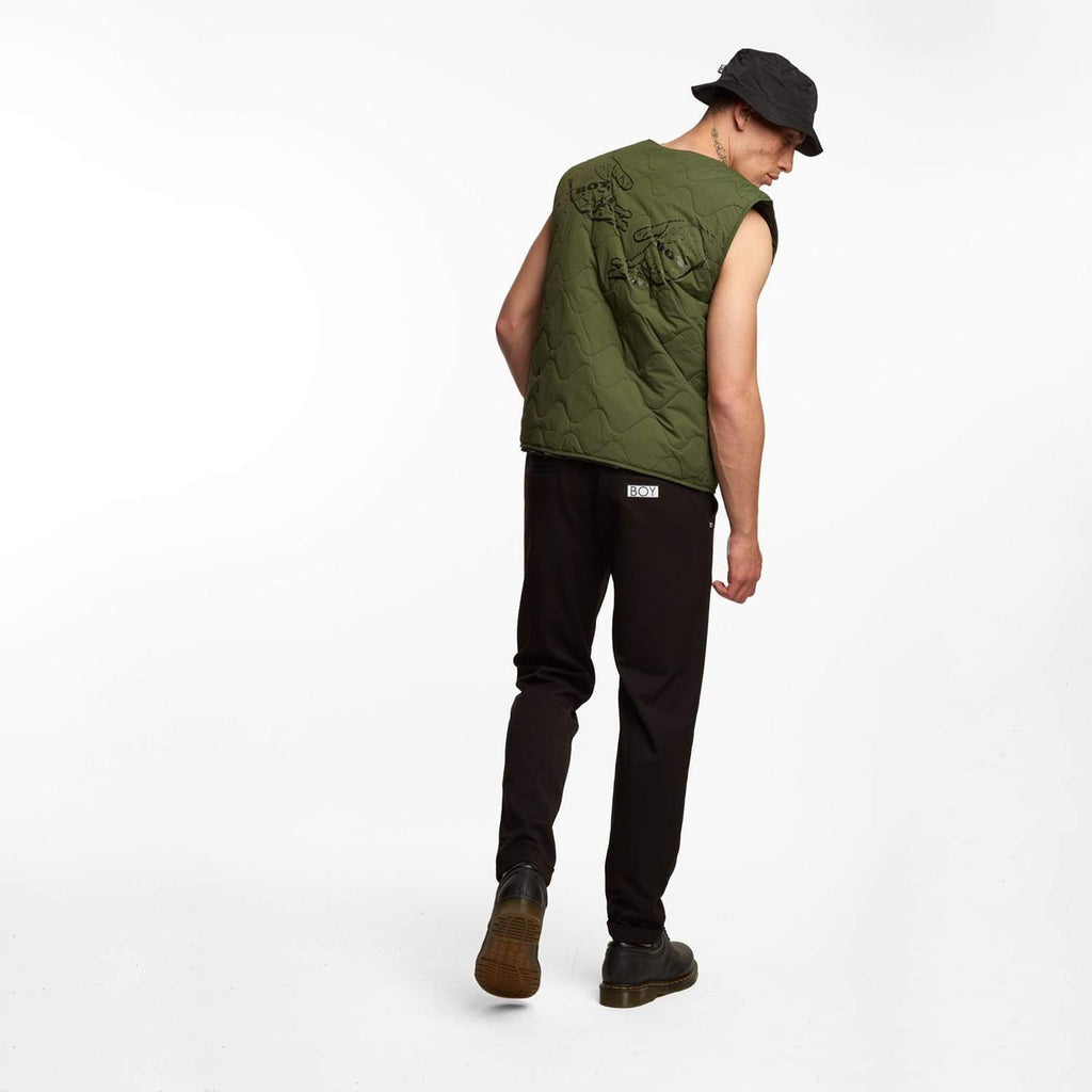 male model wearing Boy London green gilet on white background