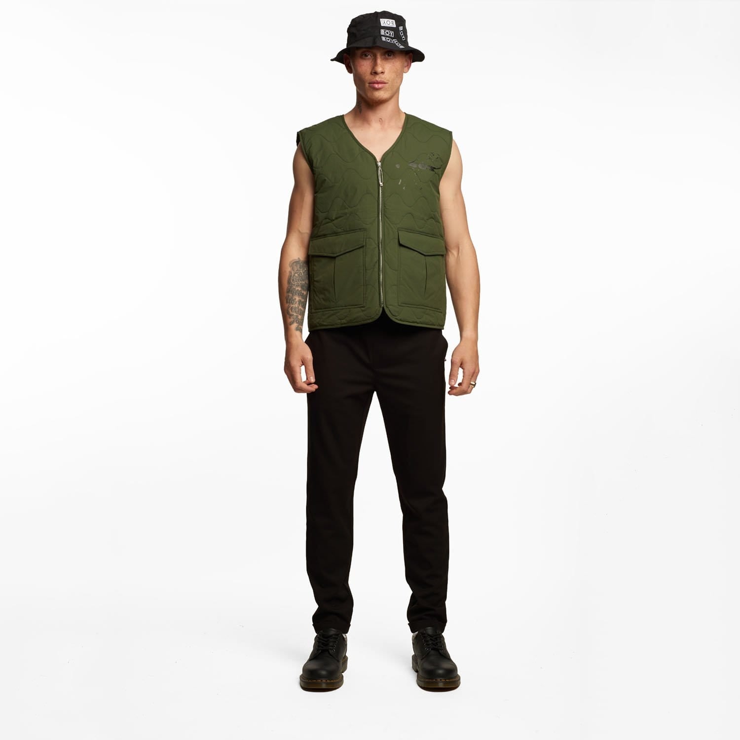 male model wearing Boy London green gilet on white background