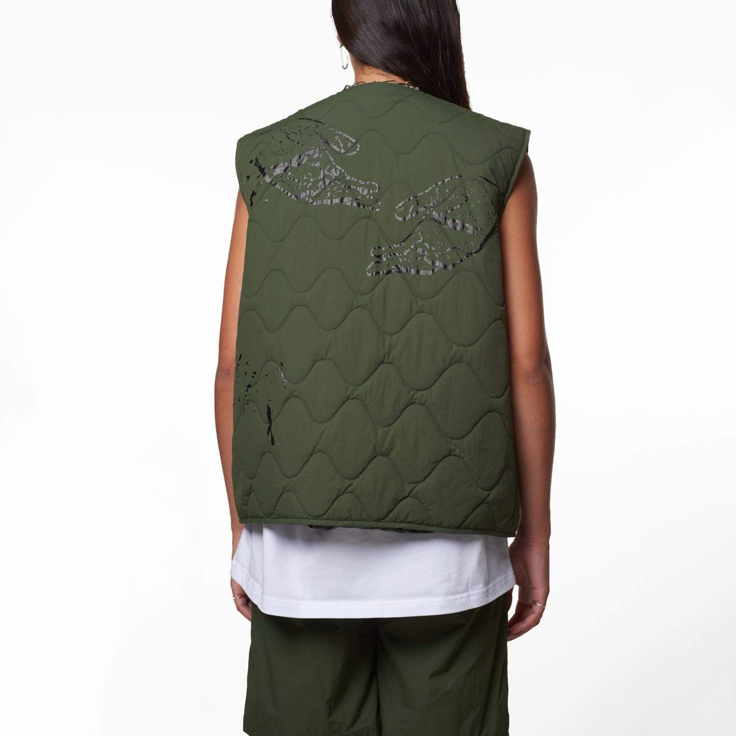 Female model wearing Boy London green gilet on white background
