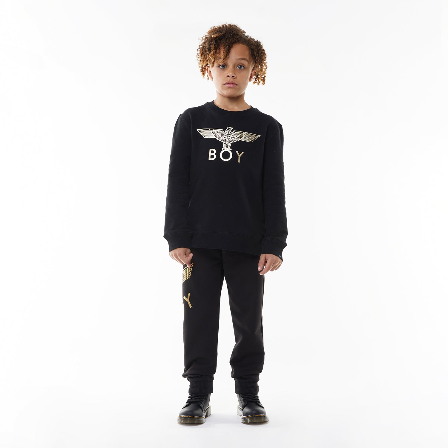 Model wearing Black sweatshirt with 'BOY' and eagle logo on a white background