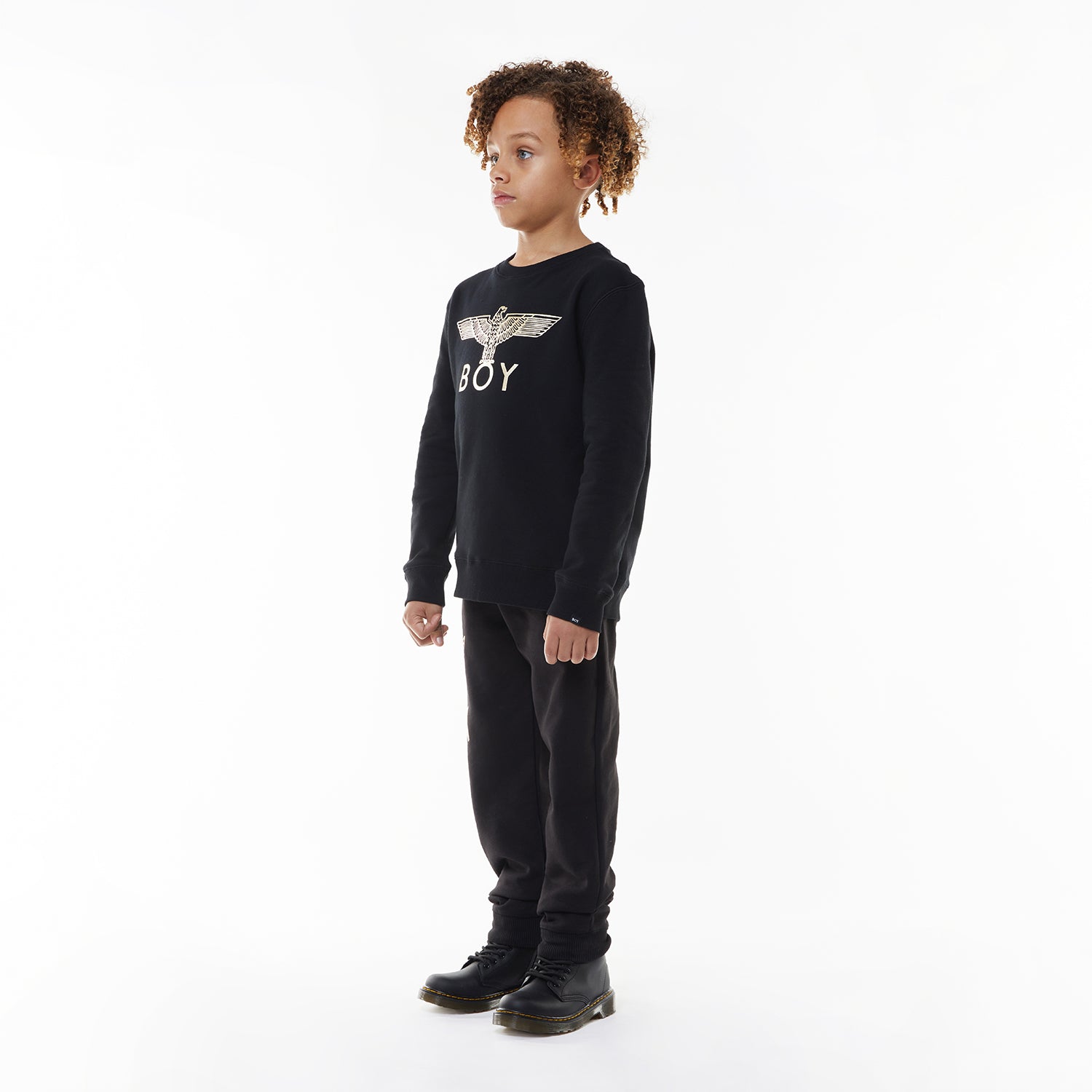 Model wearing Black sweatshirt with 'BOY' and eagle logo on a white background