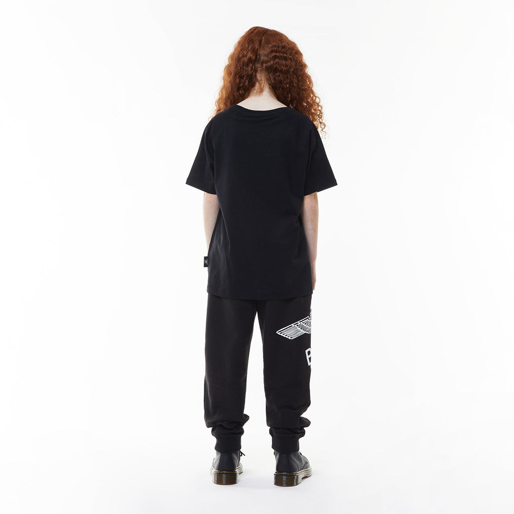 Model wearing Black t-shirt with 'BOY' logo on a white background
