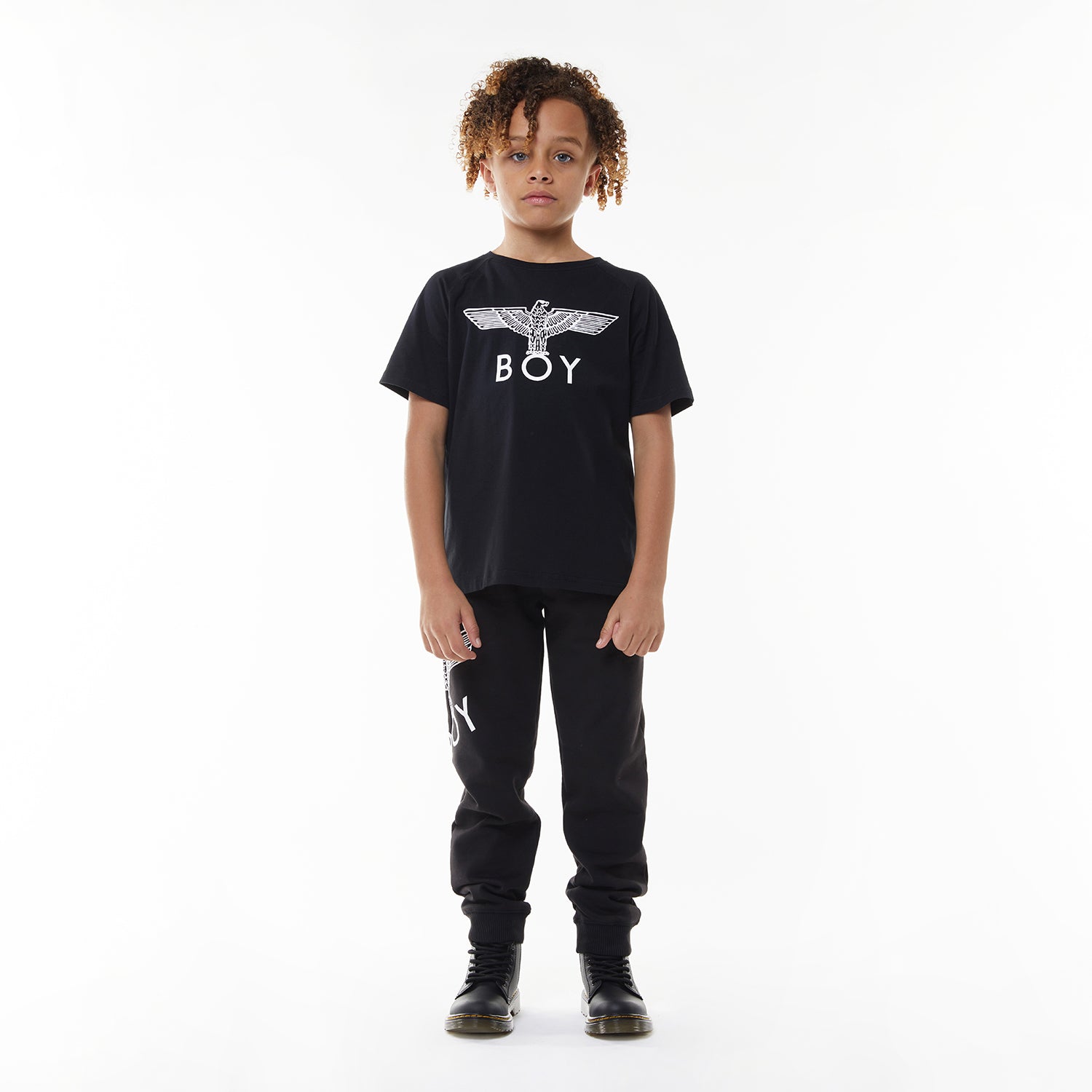 Model wearing Black t-shirt with 'BOY' logo on a white background