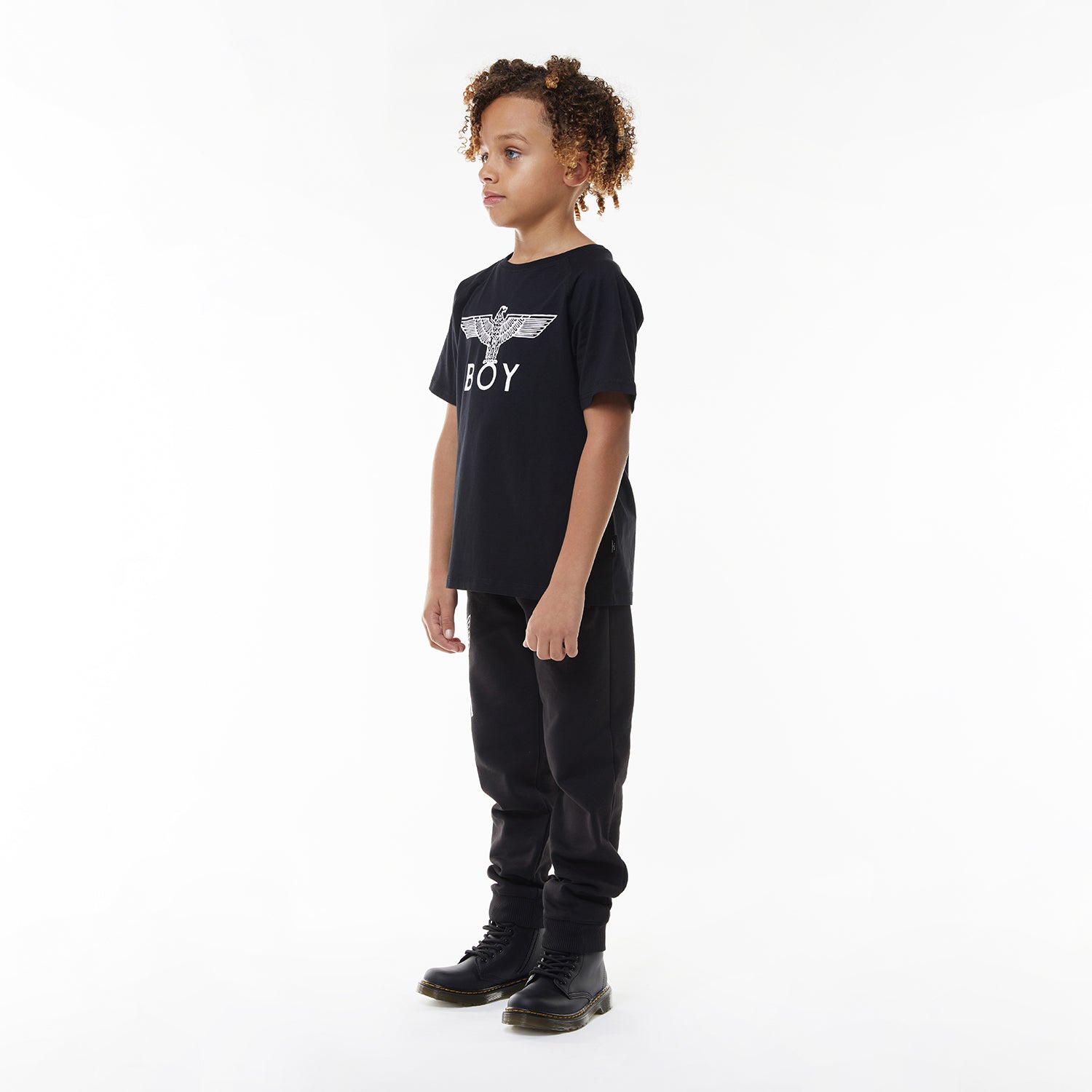 Model wearing Black t-shirt with 'BOY' logo on a white background