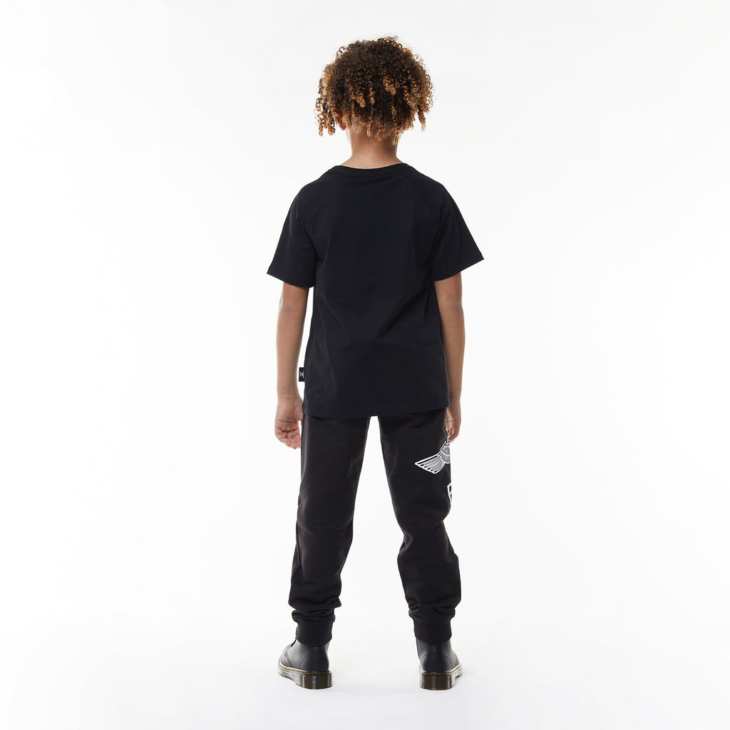 Model wearing Black t-shirt with 'BOY' logo on a white background