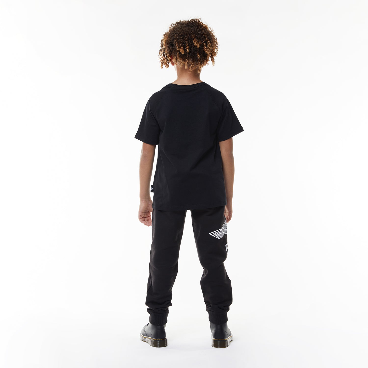 Model wearing Black t-shirt with 'BOY' logo on a white background