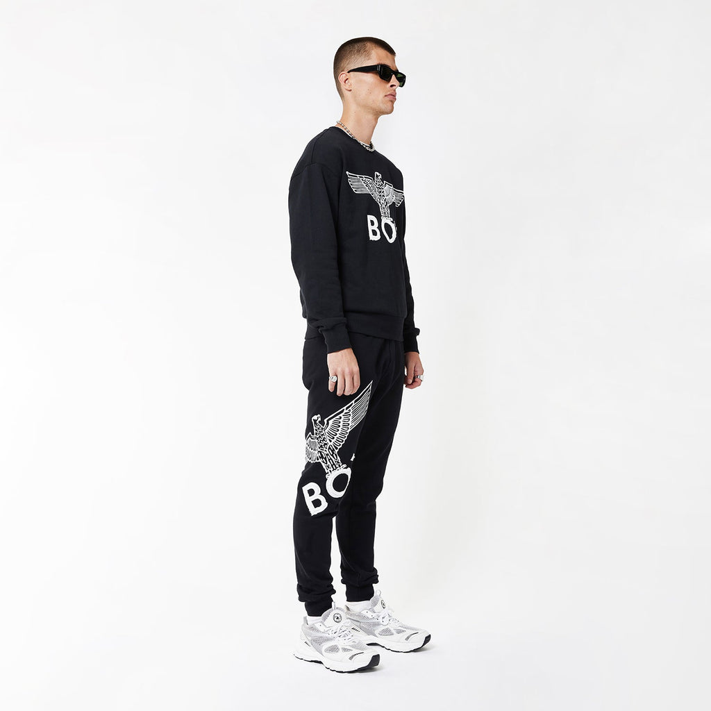 Model wearing boy london joggers on white background