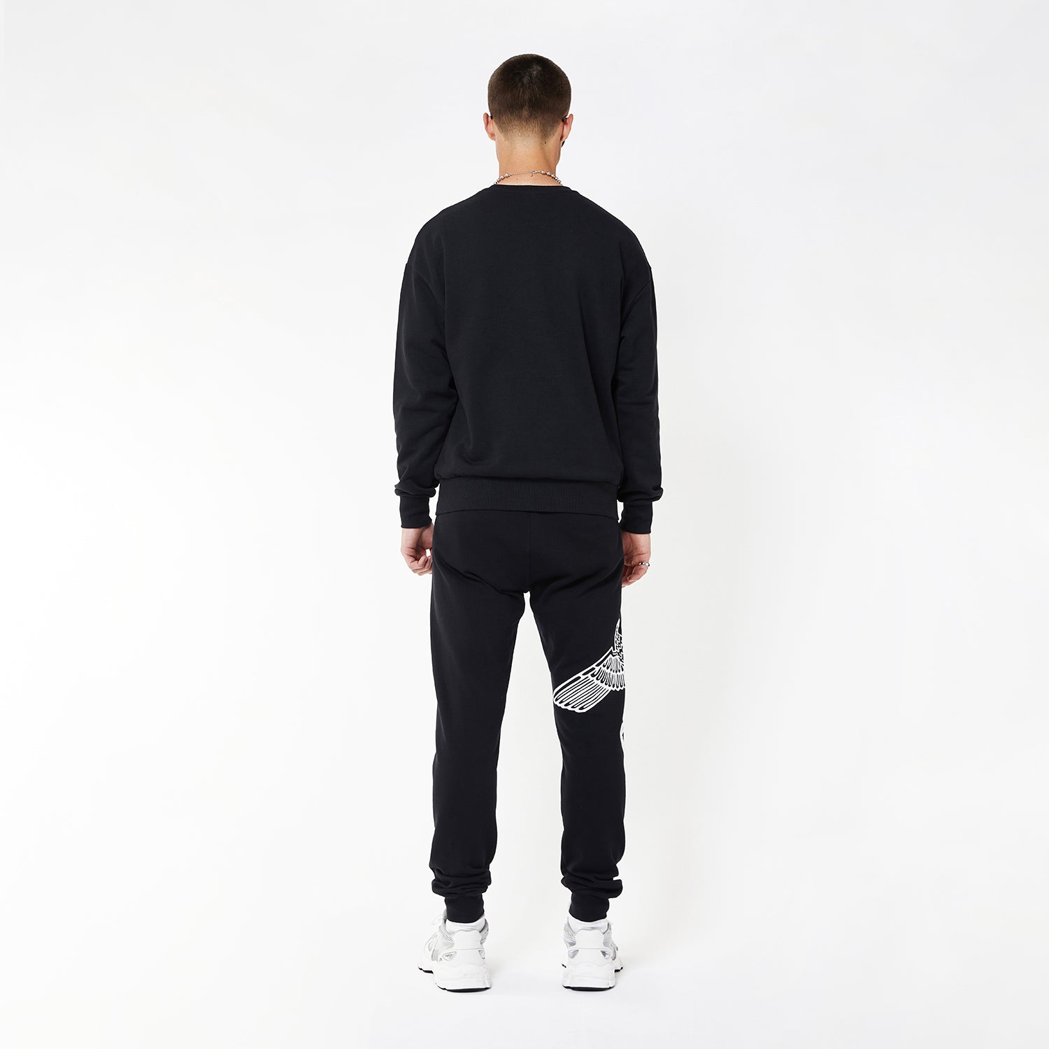 Model wearing boy london joggers on white background