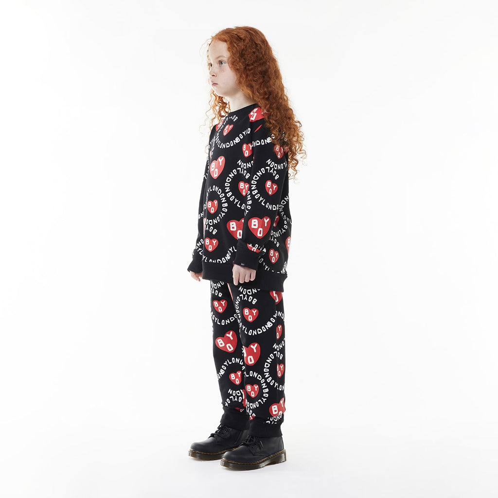 Model wearing BOY London kids joggers on white background
