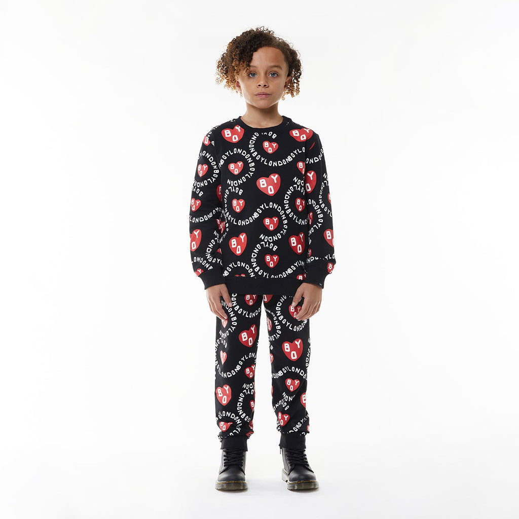 Model wearing BOY London kids joggers on white background