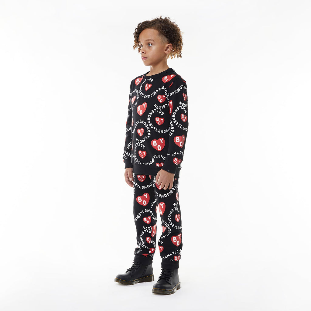 Model wearing BOY London kids joggers on white background