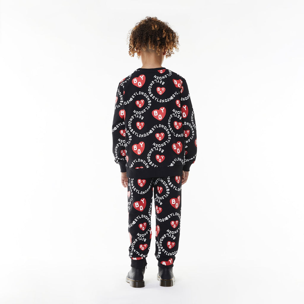 Model wearing BOY London kids joggers on white background
