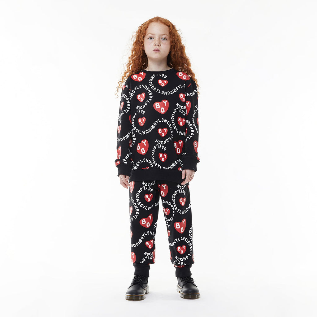 Model wearing BOY London kids joggers on white background