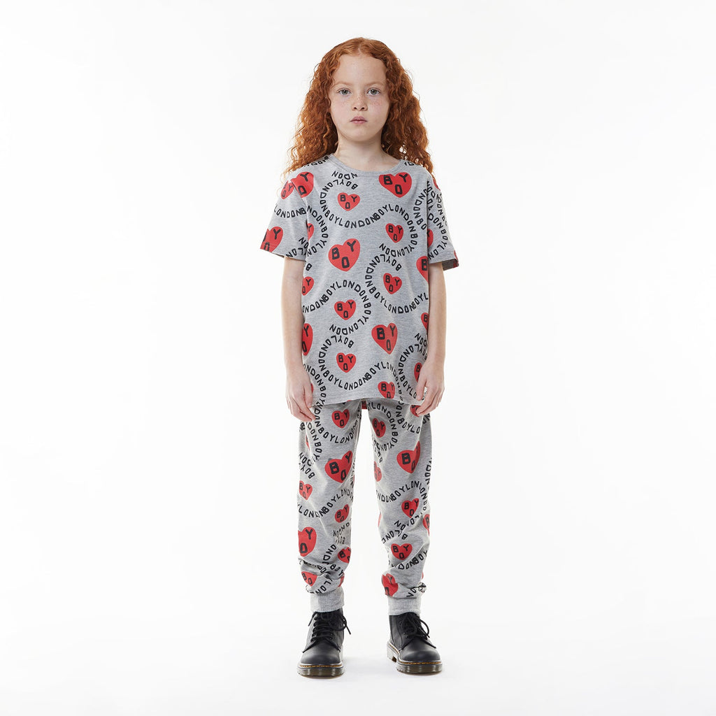 Model wearing BOY London kids joggers on white background