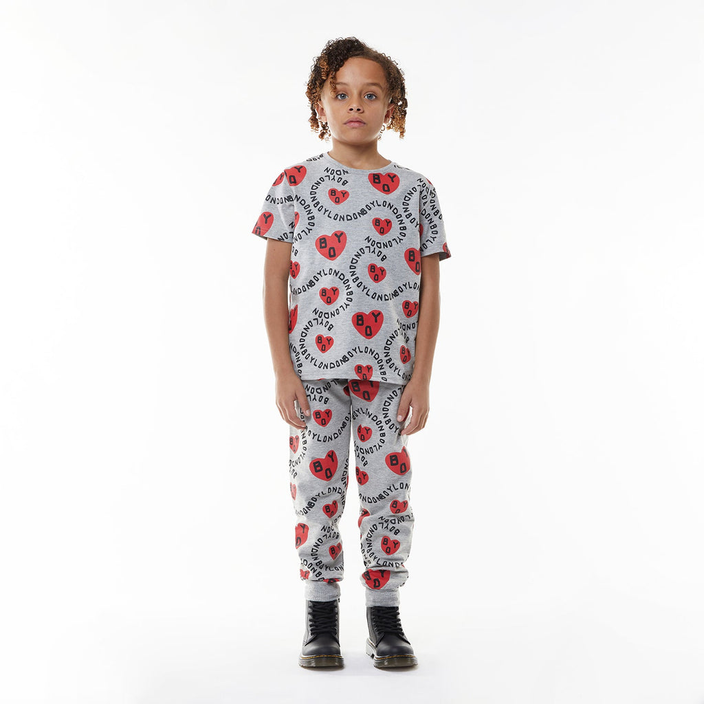 Model wearing BOY London kids joggers on white background