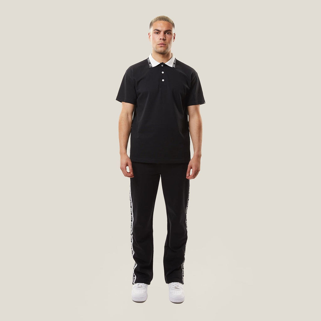 model wearing boy london joggers on plain background 
