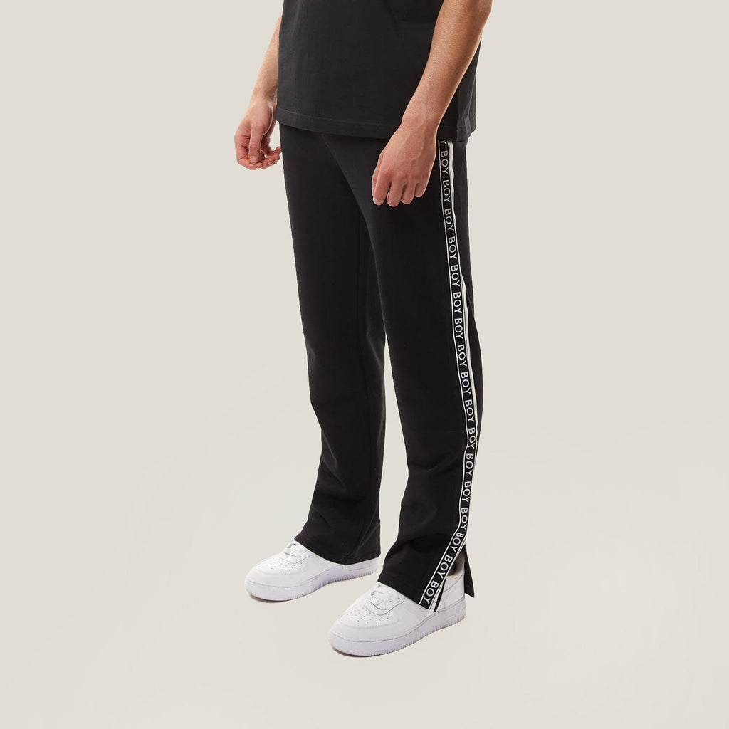 model wearing boy london joggers on plain background 