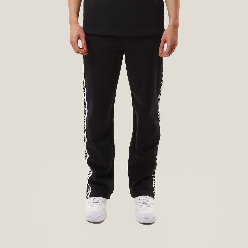 model wearing boy london joggers on plain background 