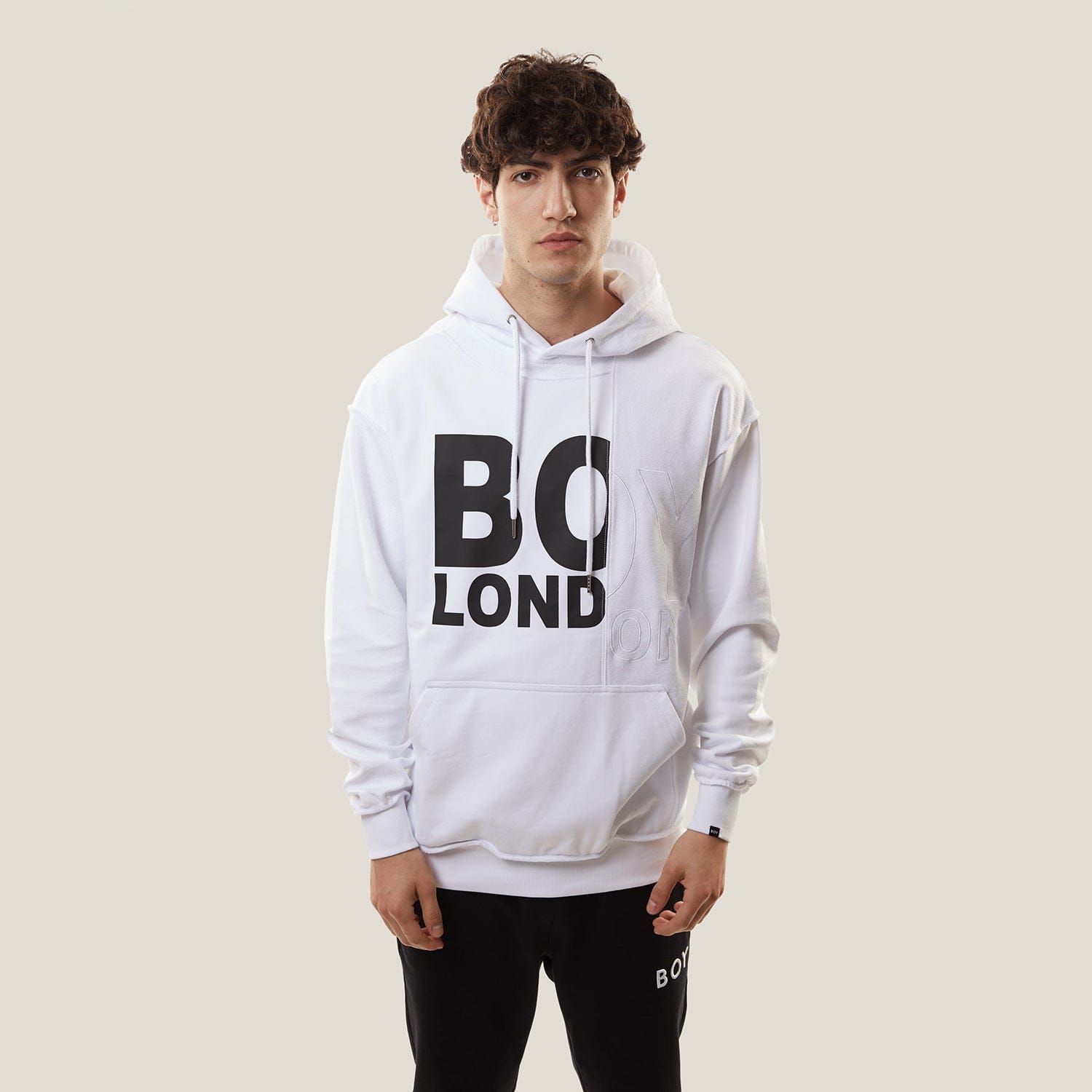 Model wearing White BOY London hoodie with text on a white background