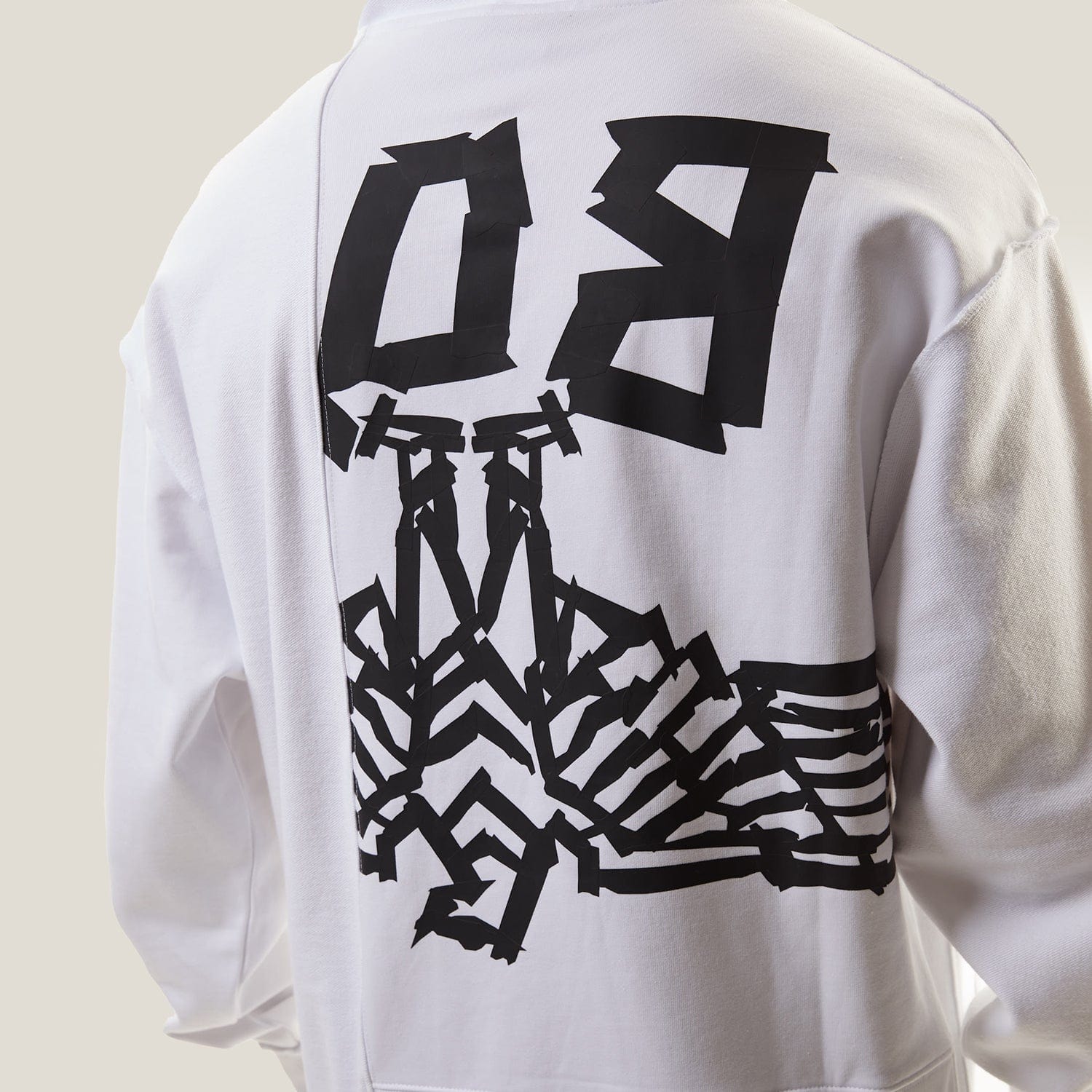 Model wearing White BOY London hoodie with text on a white background
