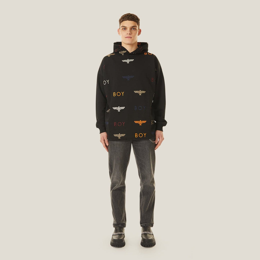 Model wearing Black hoodie with 'BOY' London and logo pattern on a white background