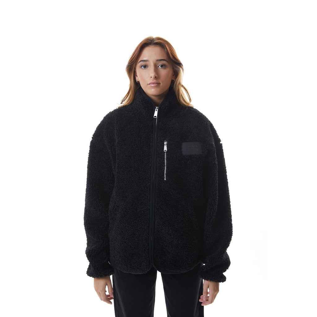 Model wearing Black BOY London fleece jacket with a brand logo on a white background
