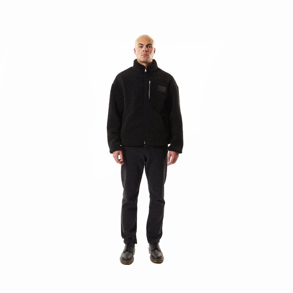 Model wearing Black BOY London fleece jacket with a brand logo on a white background