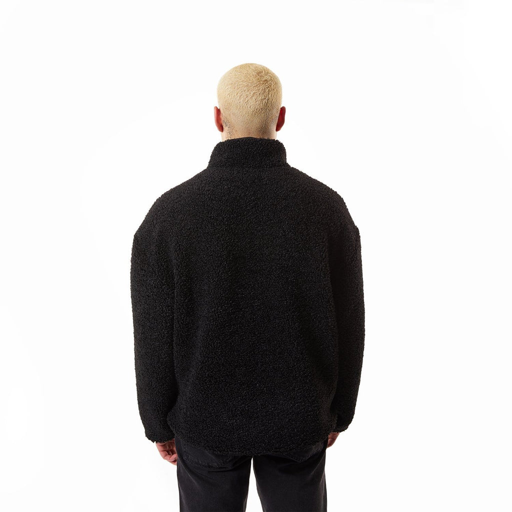 Model wearing Black BOY London fleece jacket with a brand logo on a white background