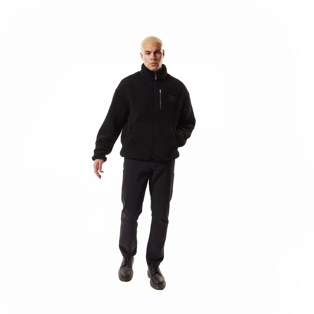 Model wearing Black BOY London fleece jacket with a brand logo on a white background