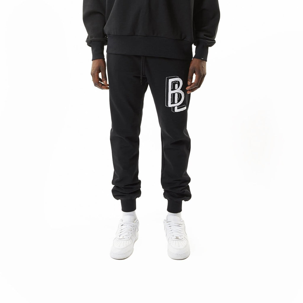 Model wearing BOY London joggers on white background