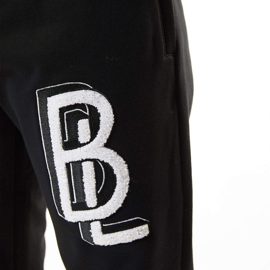 Model wearing BOY London joggers on white background