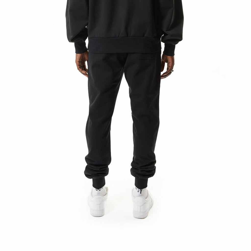 Model wearing BOY London joggers on white background