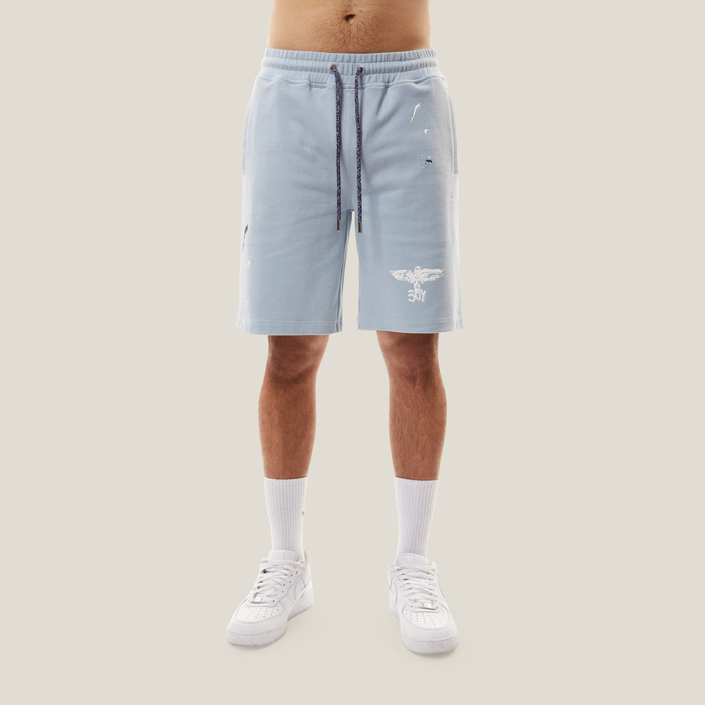Model wearing boy london shorts on white background