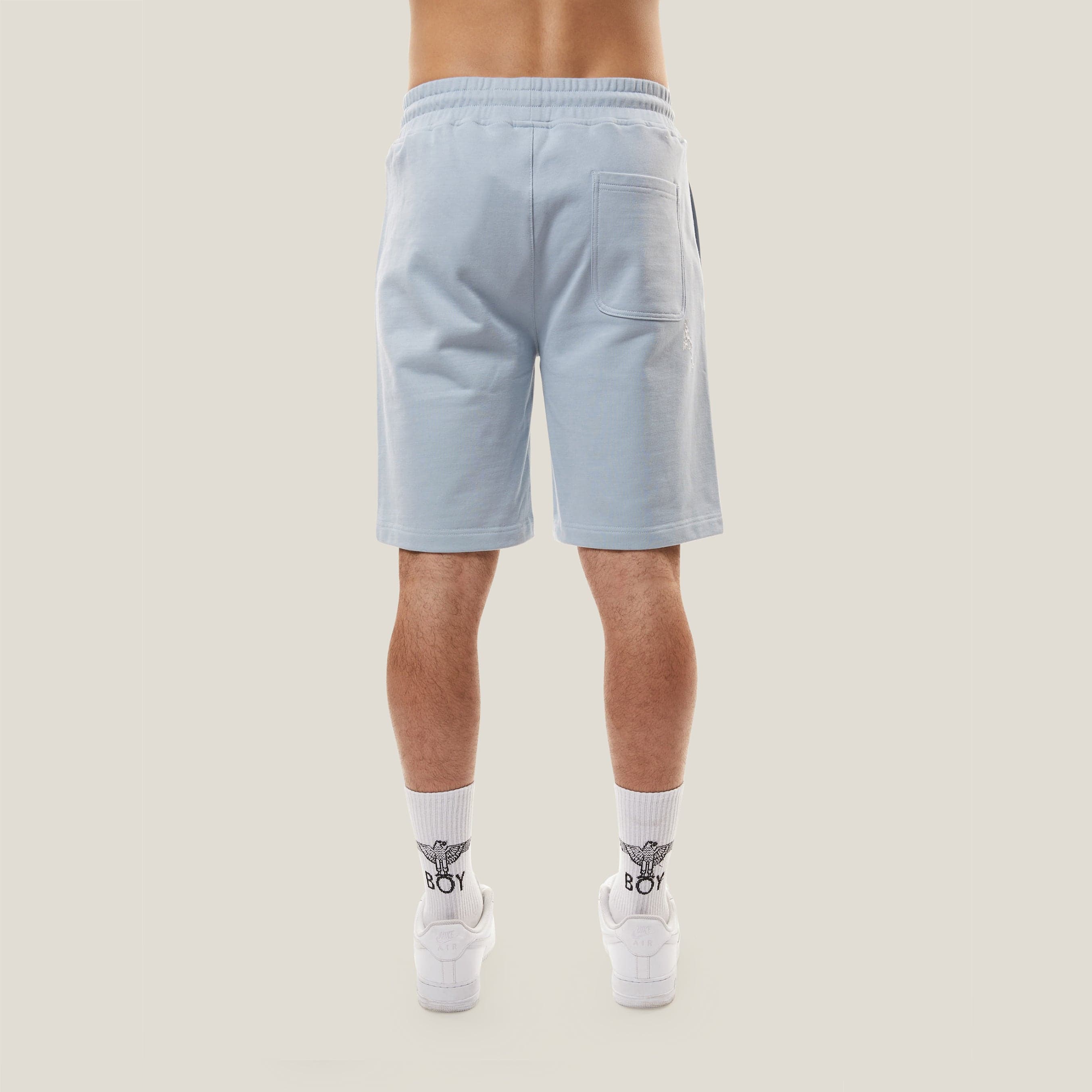 Model wearing boy london shorts on white background