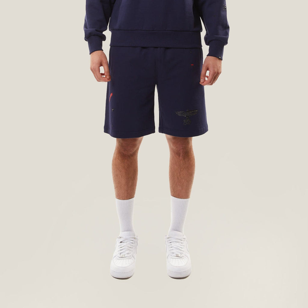 Model wearing BOY London Navy blue shorts on a white background