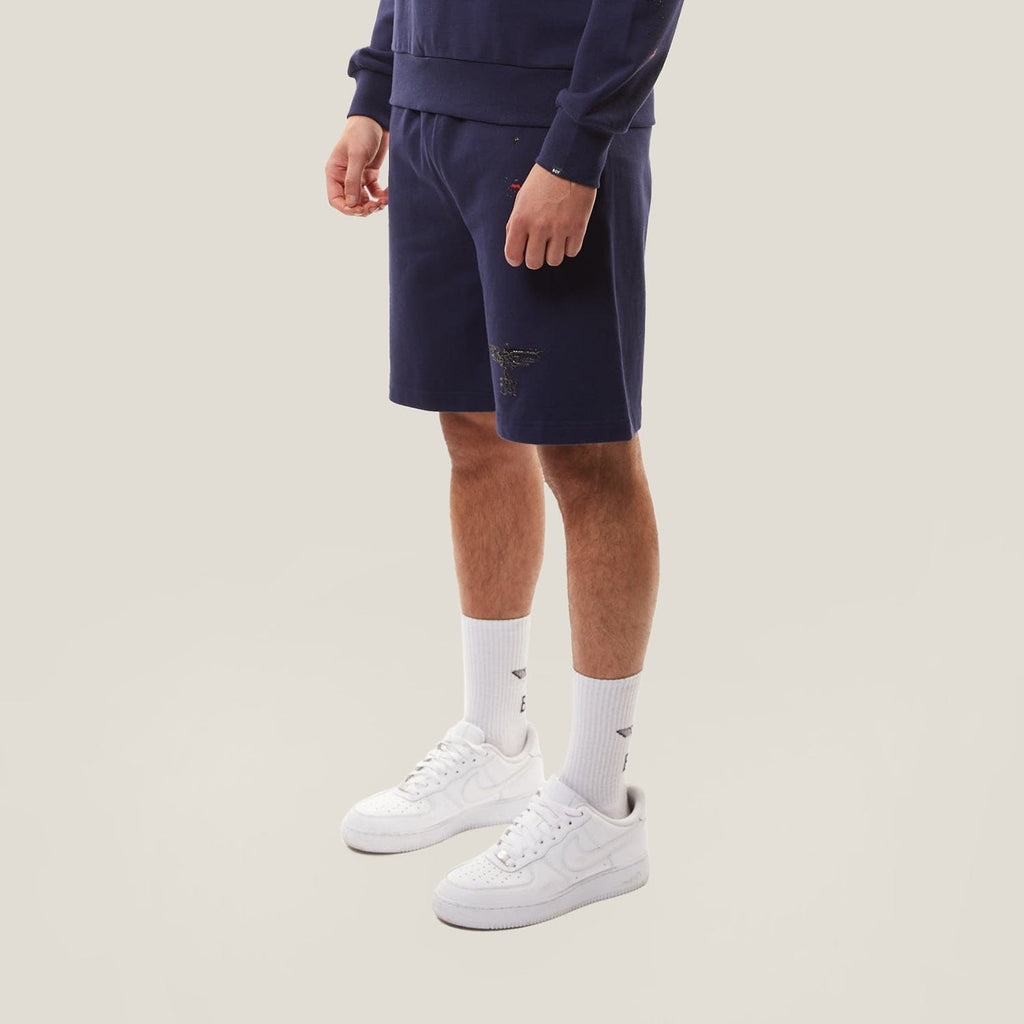 Model wearing BOY London Navy blue shorts on a white background