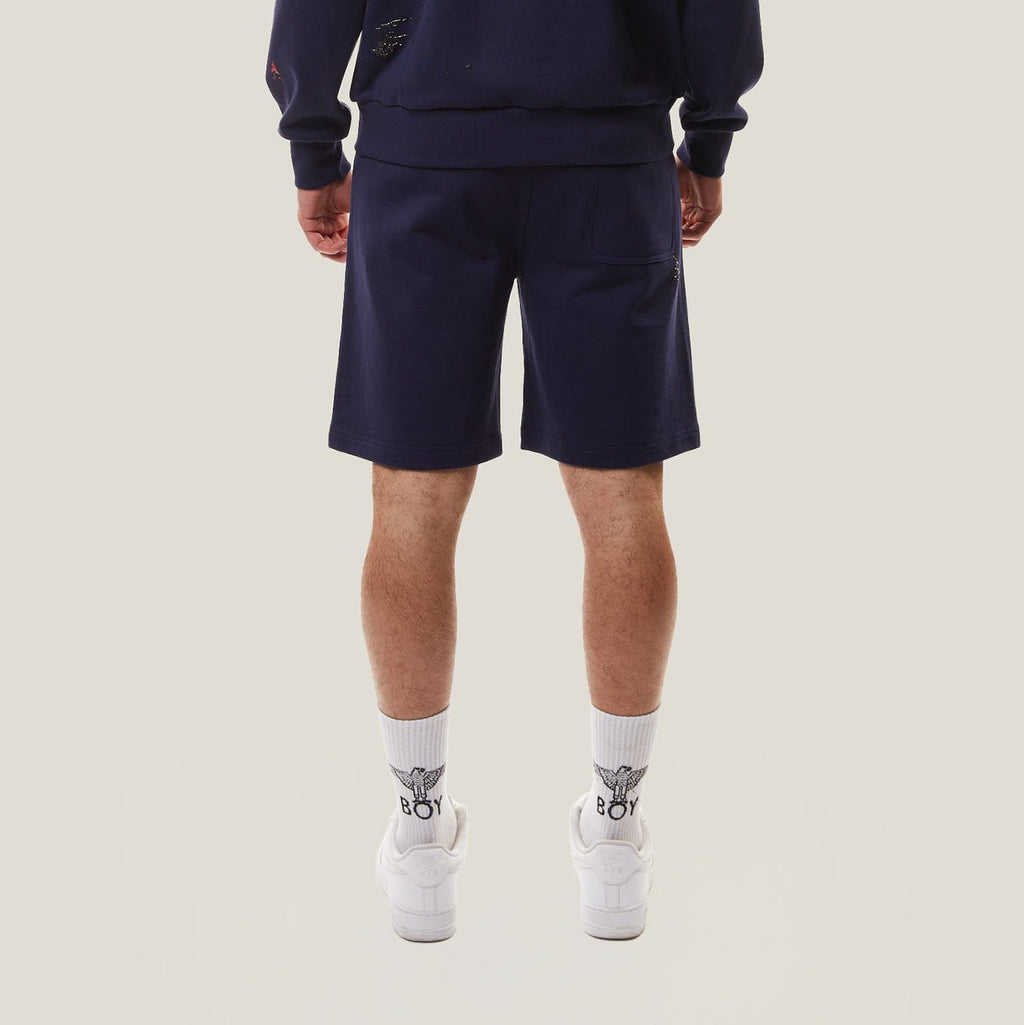 Model wearing BOY London Navy blue shorts on a white background